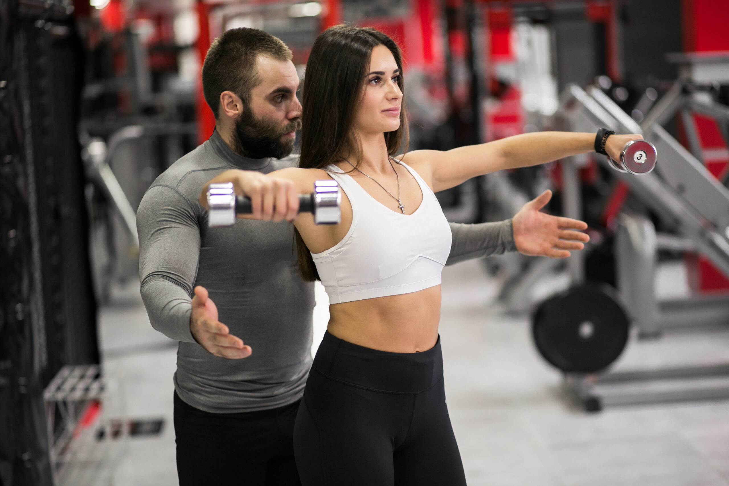 Woman at gym with trainer